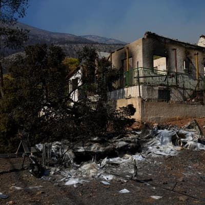 Fires ease in Greece as people return to gutted homes