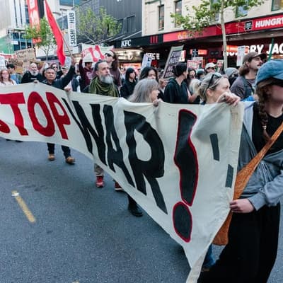 Protesters rally outside controversial weapons expo