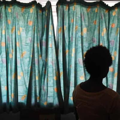 Premier defends axing family violence reform jobs